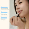 Woman applying CremeBalm lip balm, with callouts for overnight flake-softening, cooling ceramic tip with mint, and vegan cruelty-free formula